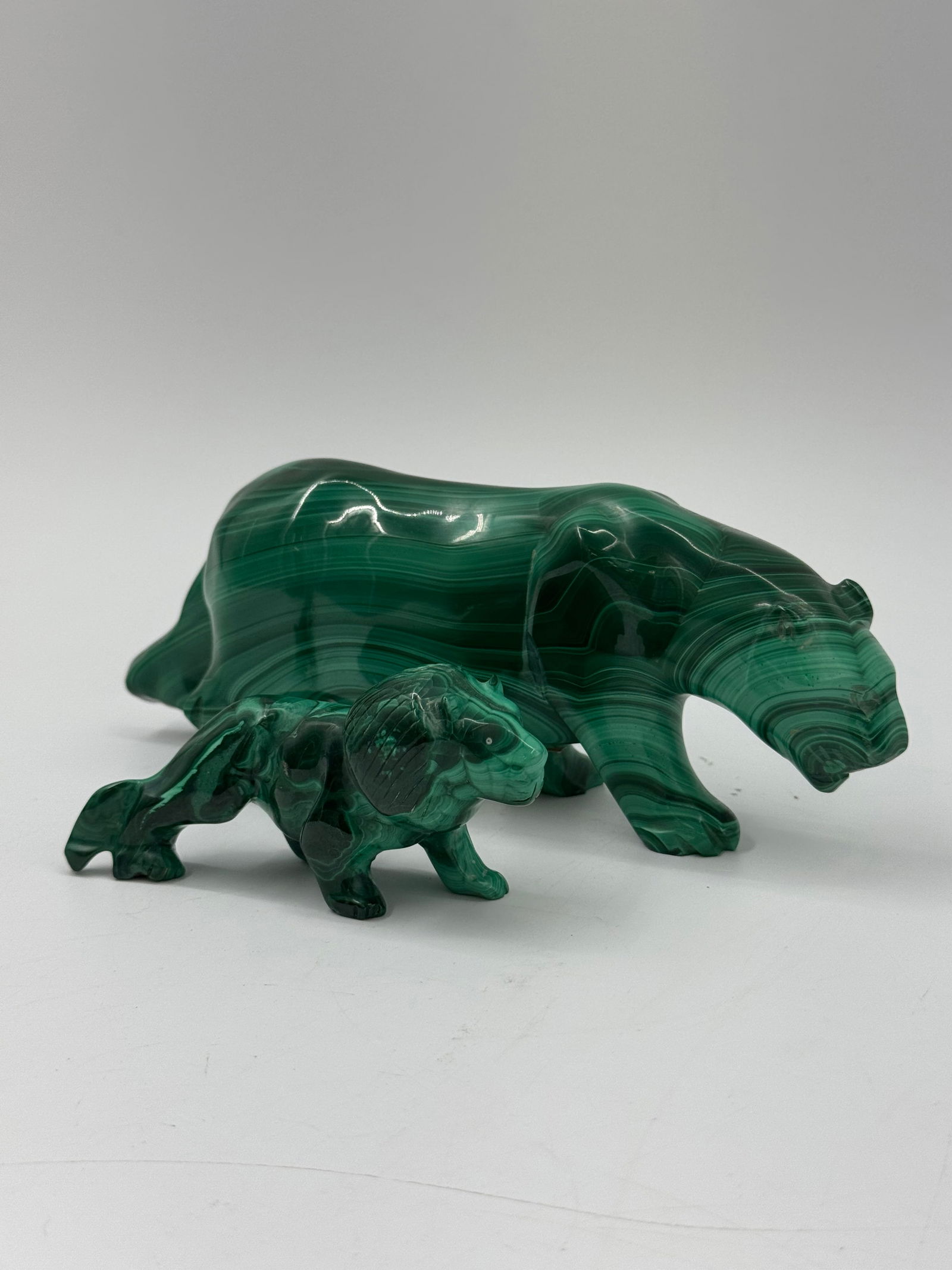 Malachite Bear and Cub Carvings: Two malachite carvings depicting bears. The larger bear measures approximately 7.5 x 3 inches, while the smaller cub measures approximately 4 x 2 inches. The carvings feature the characteristic green