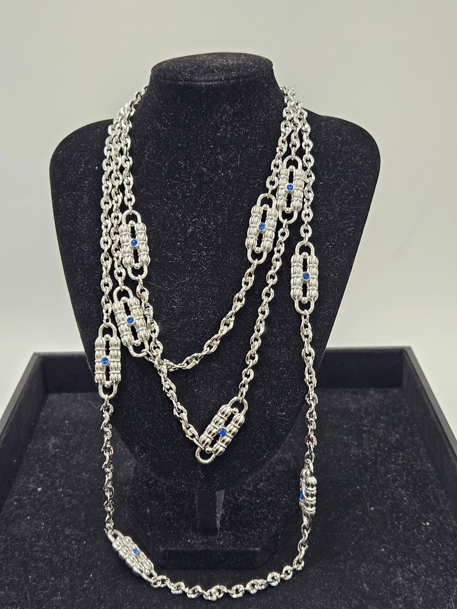 Camrose & Kross Jacqueline Kennedy Silver-Tone Necklace: An elegant silver-tone necklace by Camrose & Kross, inspired by the timeless style of former First Lady Jacqueline Kennedy. The long chain features alternating links adorned with clear and sapphir