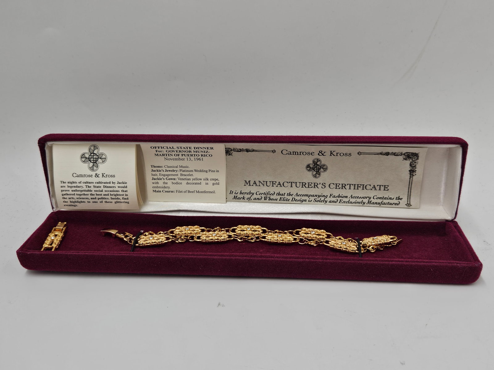 Camrose & Kross Jacqueline Kennedy Fashion Bracelet: A gold-tone bracelet by Camrose & Kross, a company known for creating authorized reproductions of jewelry worn by former First Lady Jacqueline Kennedy. Presented in its original velvet box with th