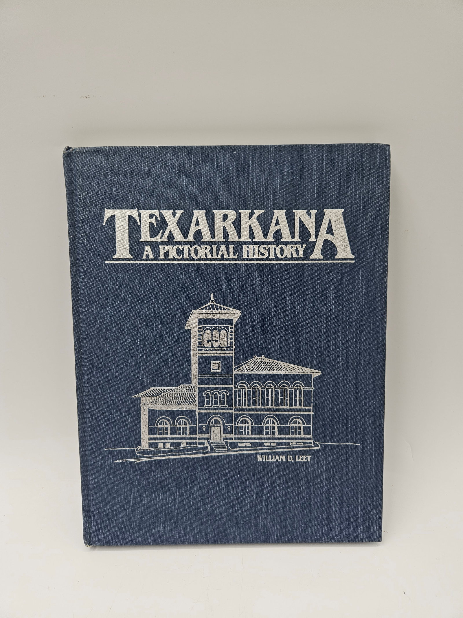 Texarkana: A Pictorial History by William D. Leet: Hardcover historical volume documenting the growth and heritage of Texarkana through rare photographs, maps, and personal accounts. Authored by William D. Leet, this book offers an engaging visual and