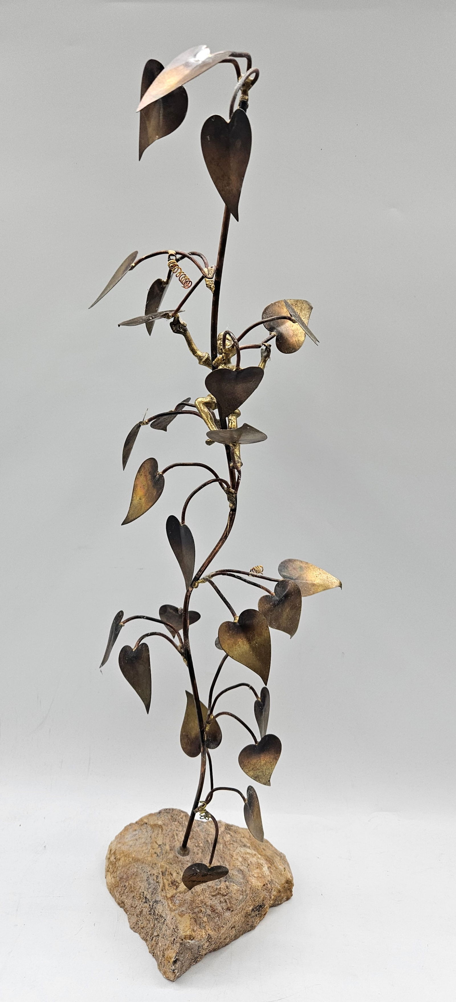 Brass and Copper Leaf Sculpture Bijan Bahar (1936-2016): Elegant mid-century metal sculpture by Bijan featuring intertwined brass and copper vines with heart-shaped leaves, mounted on a natural stone base. A signature example of Bijan’s organic modern