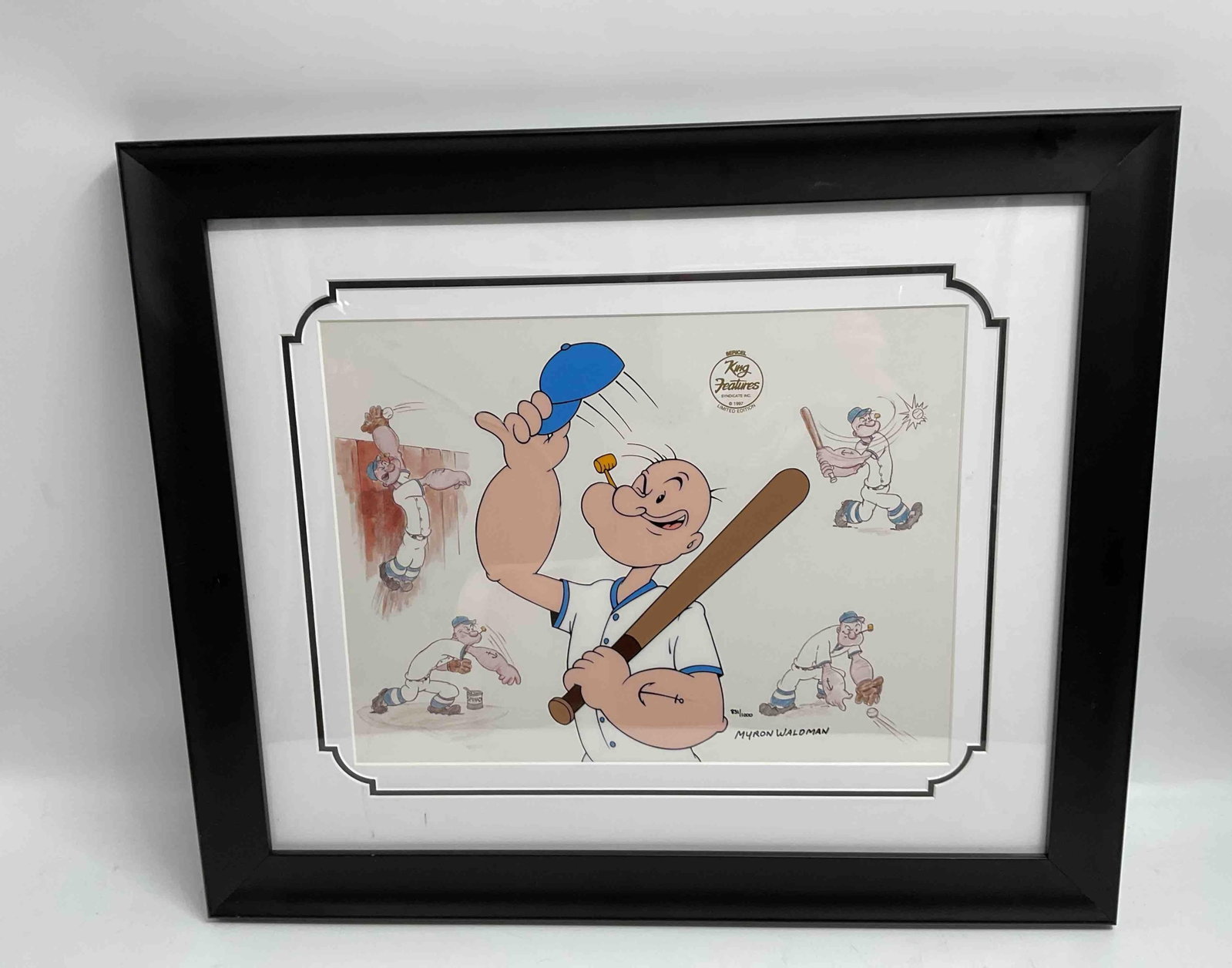 Take Him Out to the Ballgame – Popeye Sericel Signed by Myron Waldman: Limited edition Popeye sericel titled Take Him Out to the Ballgame, depicting Popeye in a whimsical baseball scene holding a bat and cap, with lively character sketches surrounding him. Personally han