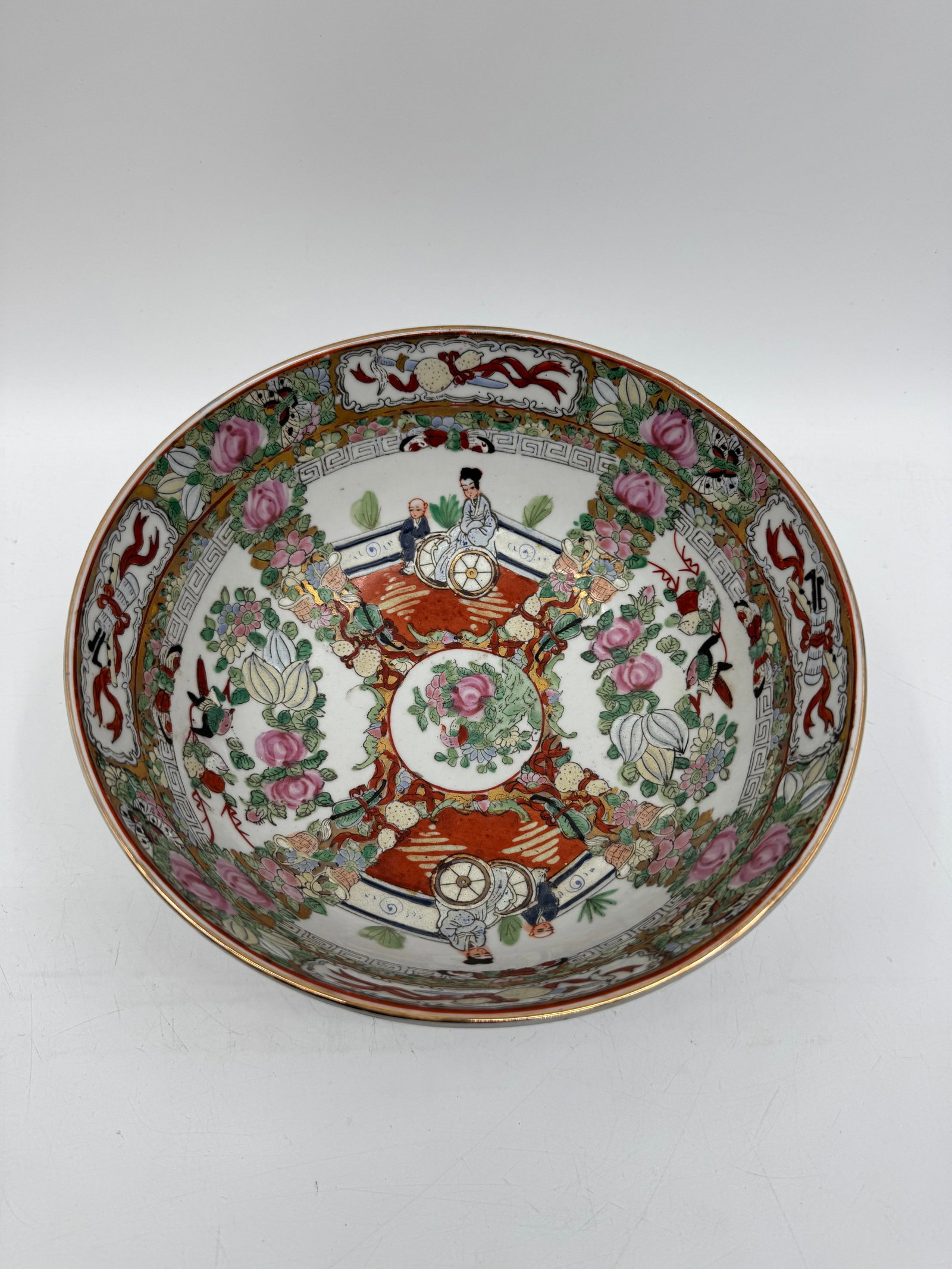 Vintage Chinese Rose Medallion Porcelain Bowl: A Chinese porcelain bowl featuring Rose Medallion pattern. The bowl measures approximately 10 inches in diameter and 4.5 inches in height. Decorated with figures, flowers, and birds. Dimensions: H: 4.