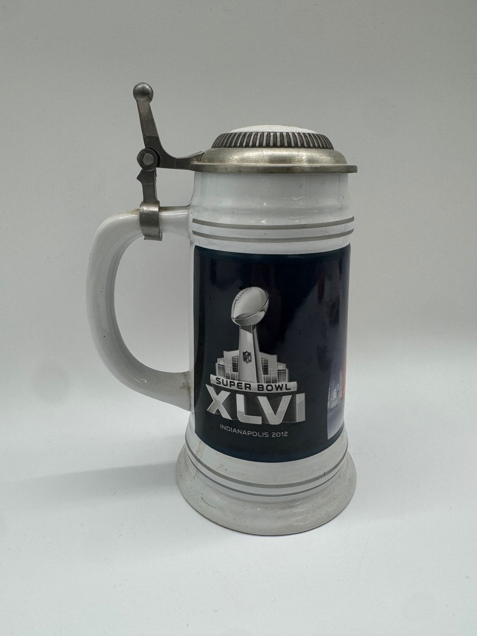 Super Bowl XLVI Commemorative Lidded Beer Stein, Indianapolis 2012: Modern Super Bowl XLVI commemorative lidded beer stein, featuring the official Lombardi Trophy logo and text “Super Bowl