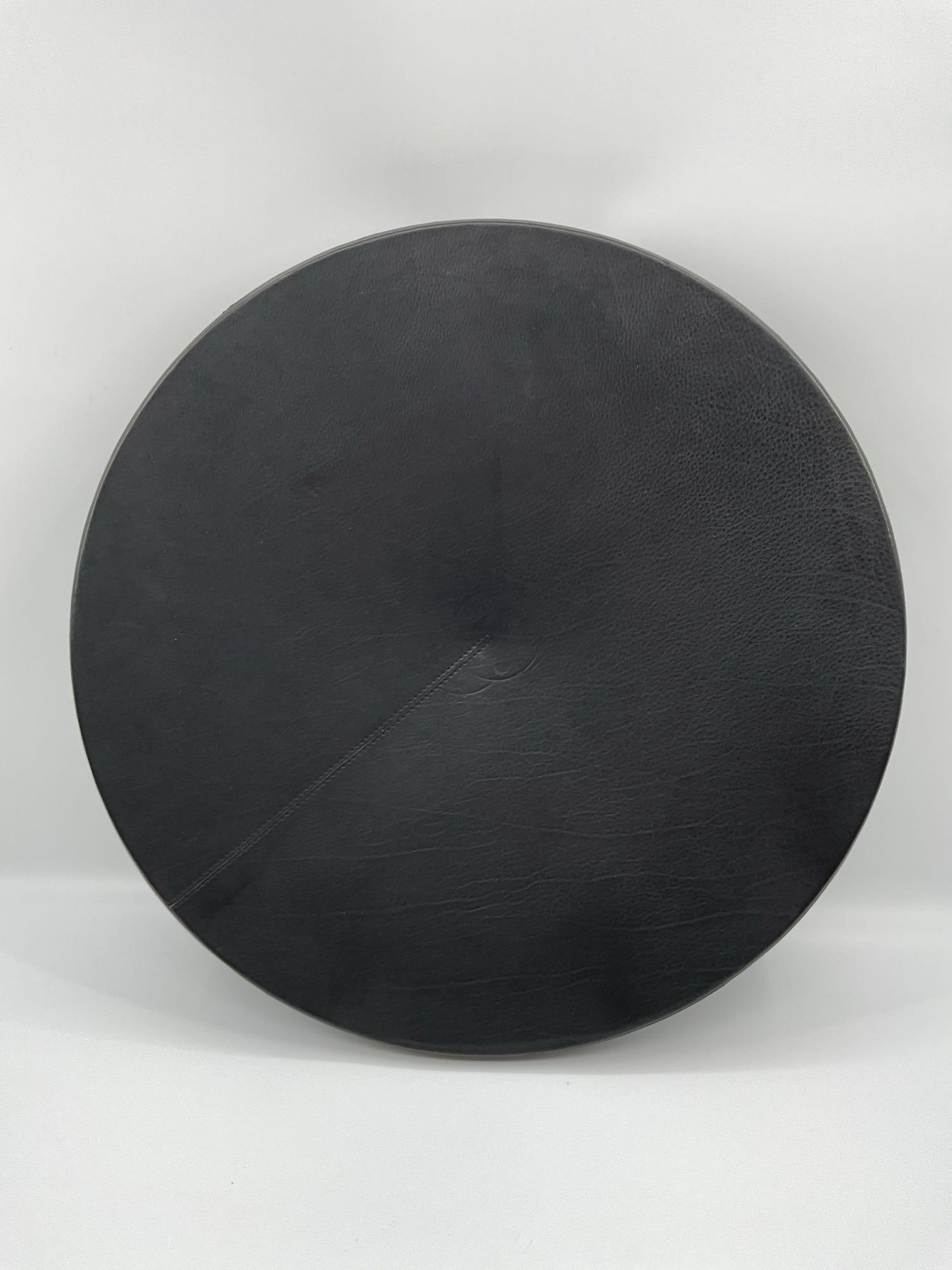 Coupe in Leather: This refined coupe form is crafted in luxurious black leather, featuring a shallow, wide bowl with a precise and subtle seam detail. The surface is smooth with natural leather grain, giving the piece