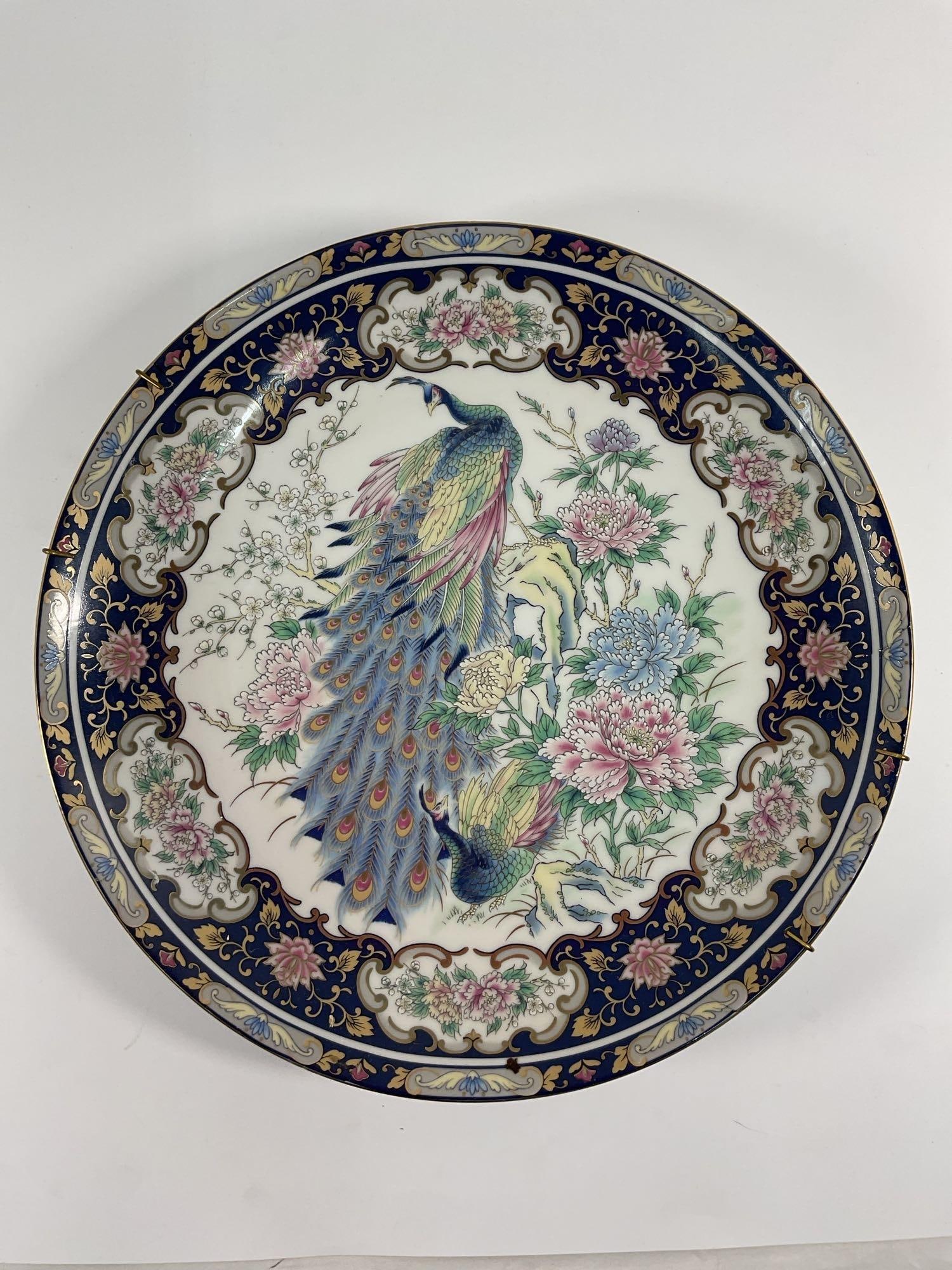 Antique Toyo Chinese Porcelain Peacock Plate: This exquisite porcelain plate features a detailed hand-painted peacock surrounded by delicate floral motifs. The border is adorned with a deep cobalt blue and gold-accented pattern, indicative of tra