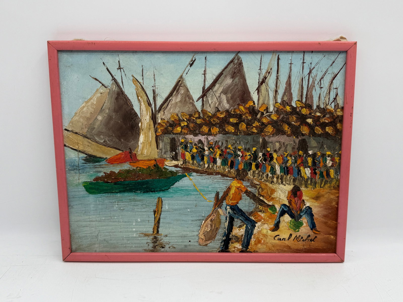 Carl Michel Haitian Harbor Scene Oil Painting: Oil painting on board depicting a Haitian harbor scene with boats, figures, and buildings. Signed "Carl Michel" in the lower right. Framed. Dimensions: 17 x 13 inches.