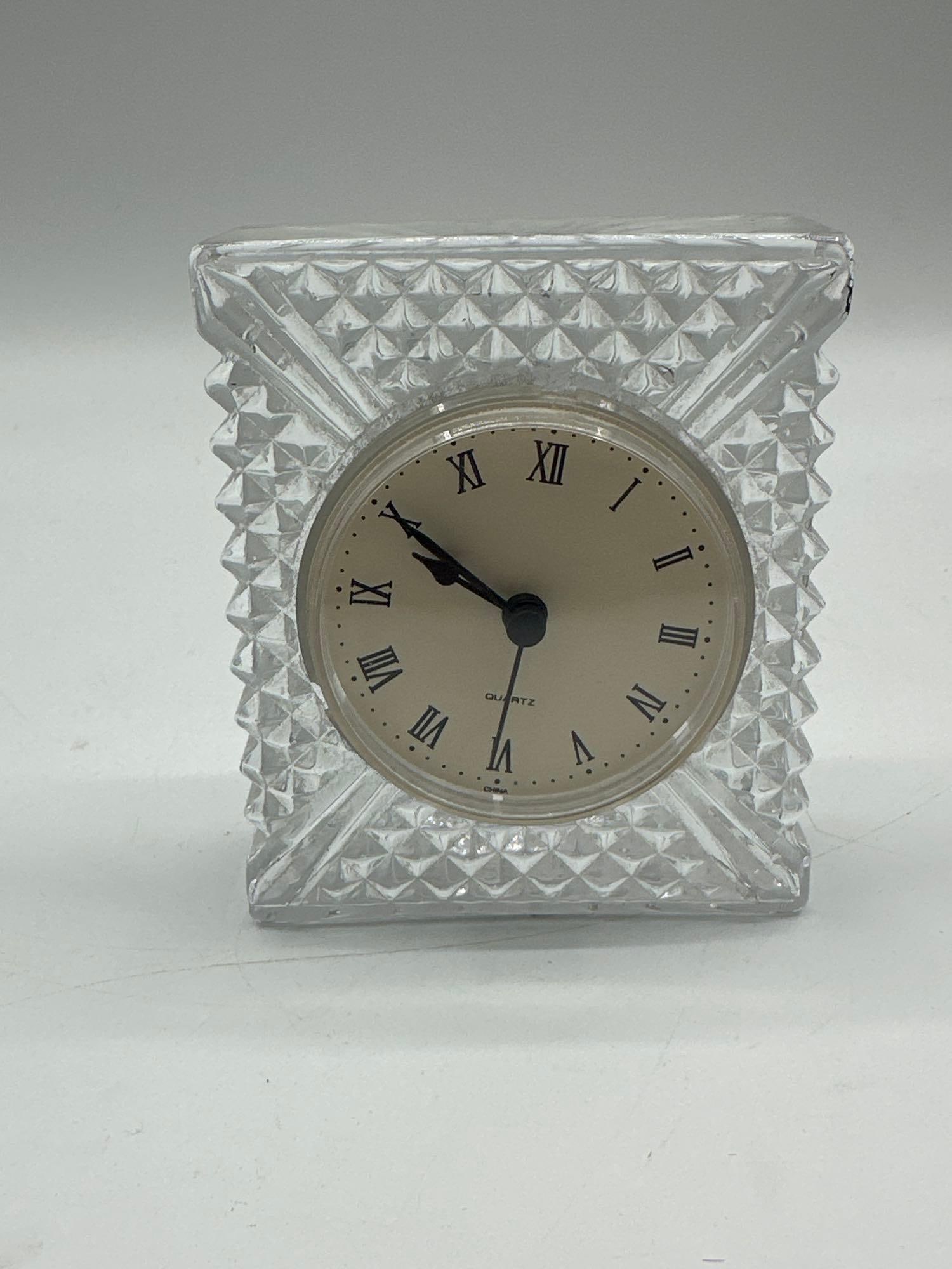 Cut Glass Quartz Desk Clock: Small rectangular cut glass desk clock with geometric diamond-point design and Roman numeral quartz dial. Features clear stepped sides and a round insert movement. Noted surface wear and chipping on o