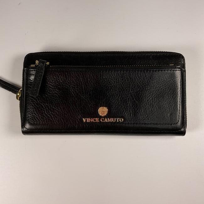 Vince Camuto Leather Wallet: A sleek and sophisticated Vince Camuto leather wallet crafted with precision. The wallet features a minimalist black exterior adorned with the Vince Camuto emblem in gold. The spacious interior is des