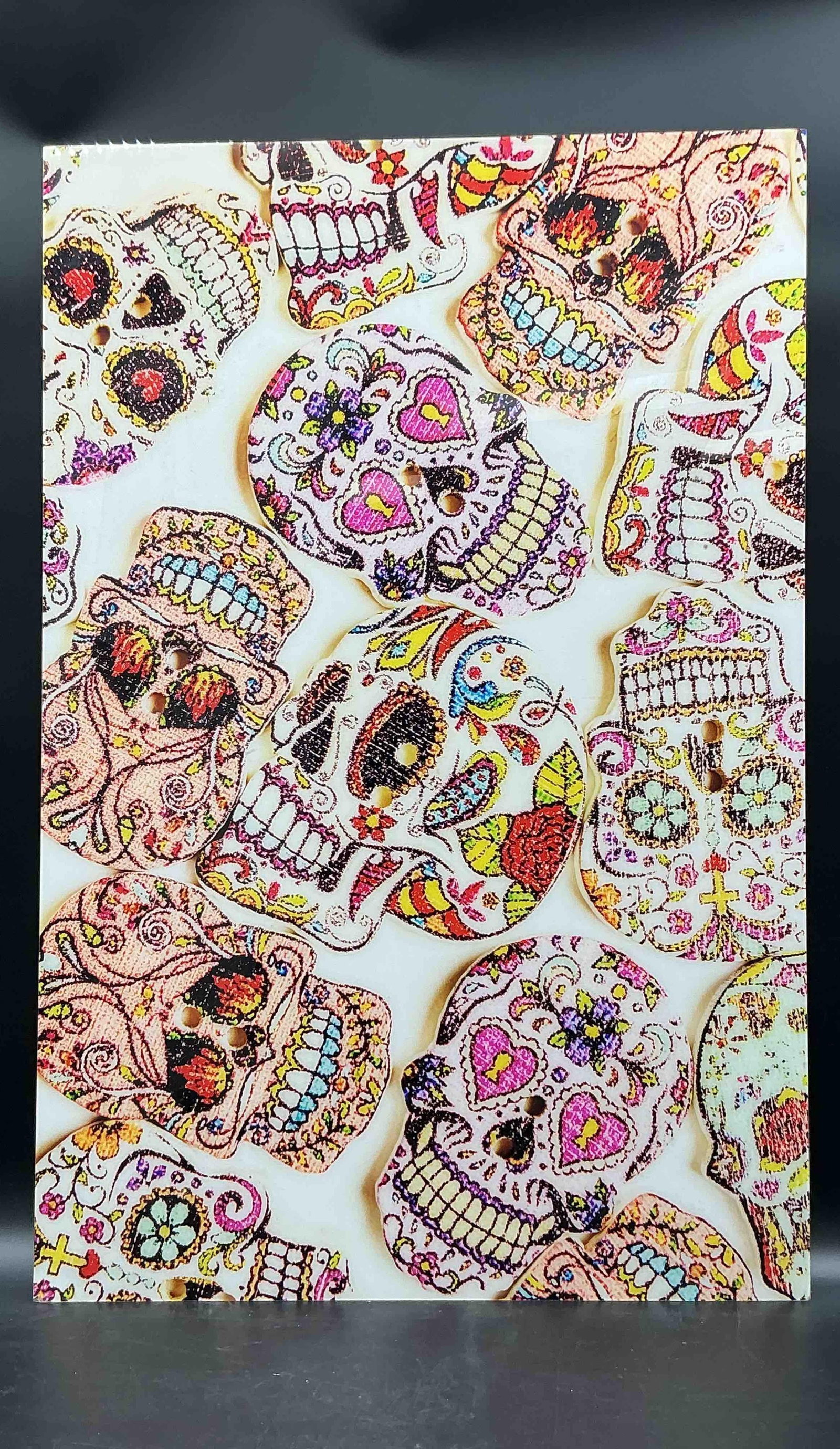 Day of the Dead Sugar Skull Canvas Art: Vibrant wall art featuring a collage of colorful sugar skulls inspired by Día de los Muertos, accented with glitter and embellishments for a textured effect Medium: acrylic 