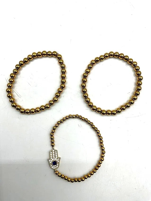 Gold-Tone Beaded Necklace with Rhinestone Clasp: A classic strand of metallic gold-tone beads featuring a rhinestone-encrusted clasp with a central blue accent stone. Elegant and versatile piece, suitable for formal or evening wear. Dimensions: Diam
