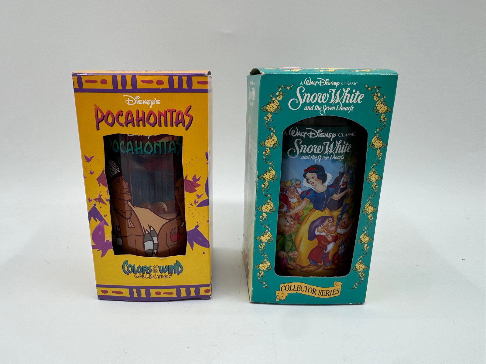 Disney Pocahontas & Snow White Collector's Glasses in Boxes: Two Disney collector's glasses, each in its original box. One features Pocahontas, and the other features Snow White. Each box measures approximately 6 x 3 inches.