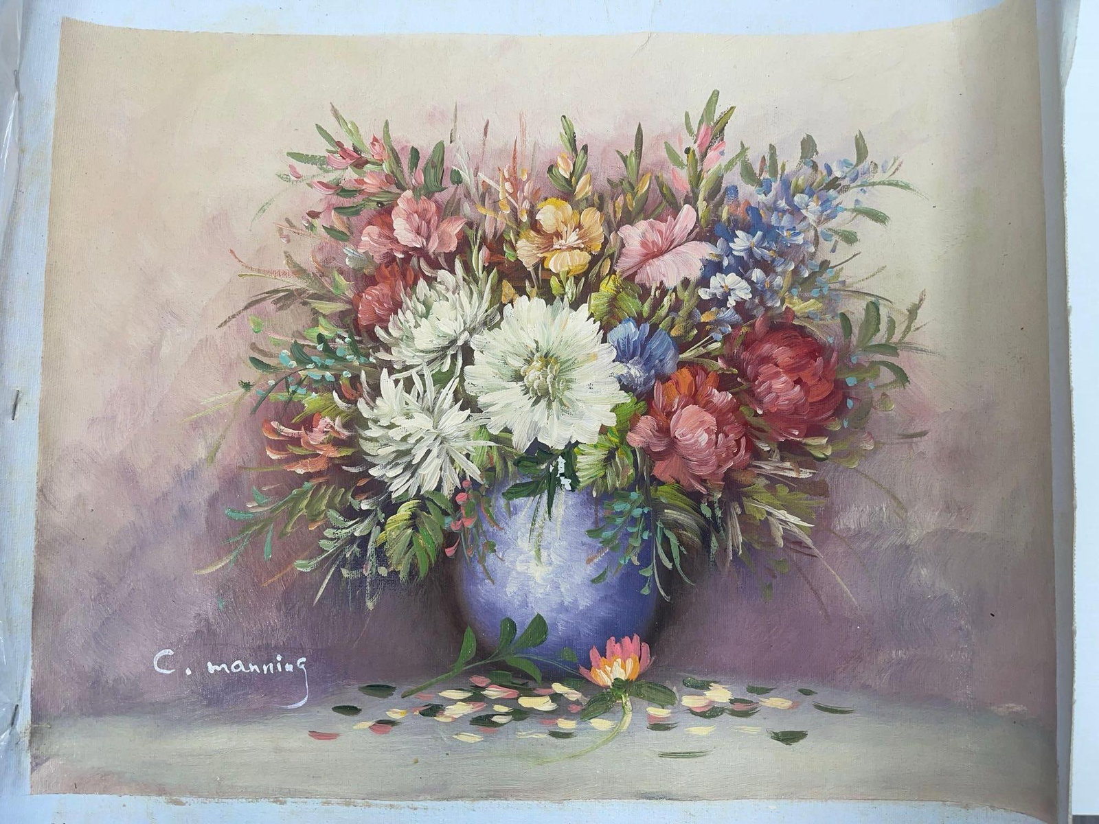 Floral Still Life in Purple Vase by Charles Manning Oil on Canvas: Lush bouquet of assorted flowers in a purple vase, featuring white chrysanthemums, pink roses, and blue wildflowers against a soft gradient background. Signed C. Manning. Dimensions: H16in L19in Mediu
