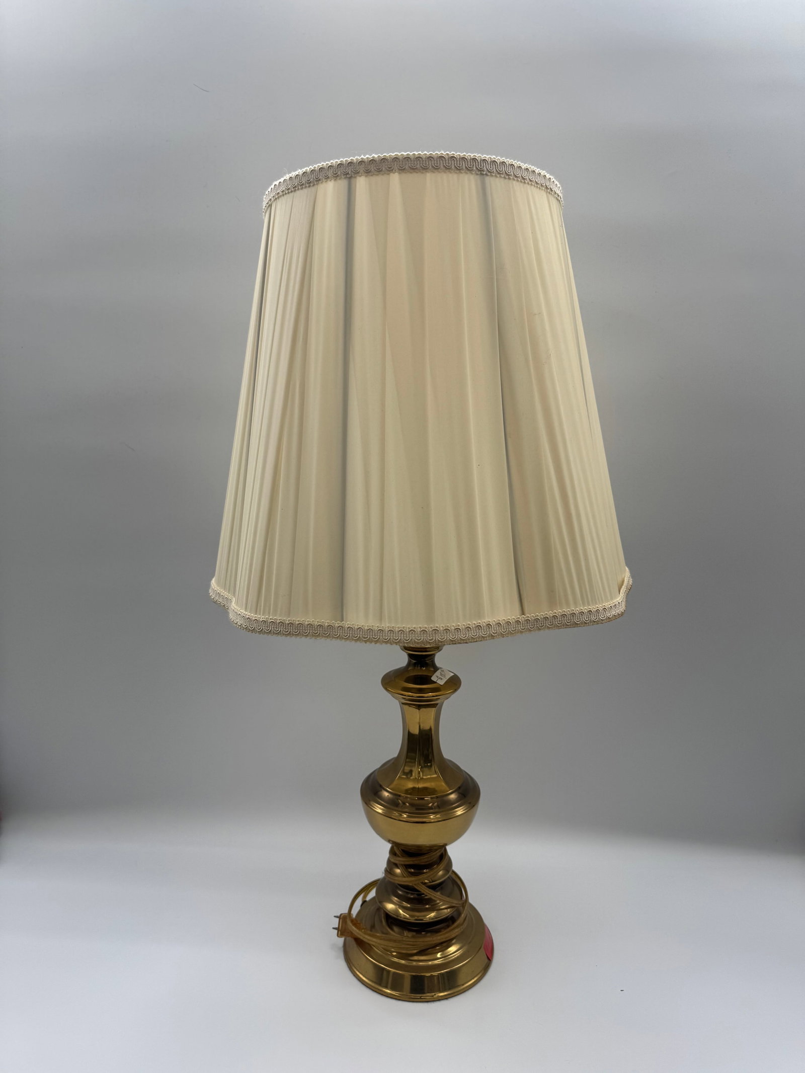 Brass Table Lamp with Shade: Vintage brass table lamp with a pleated fabric shade. Dimensions: H: 32 W:17 in