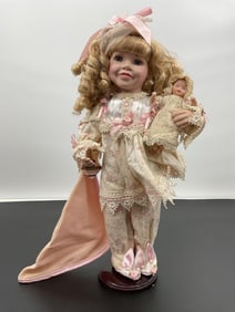 Porcelain Doll in Pajamas Holding Baby Doll