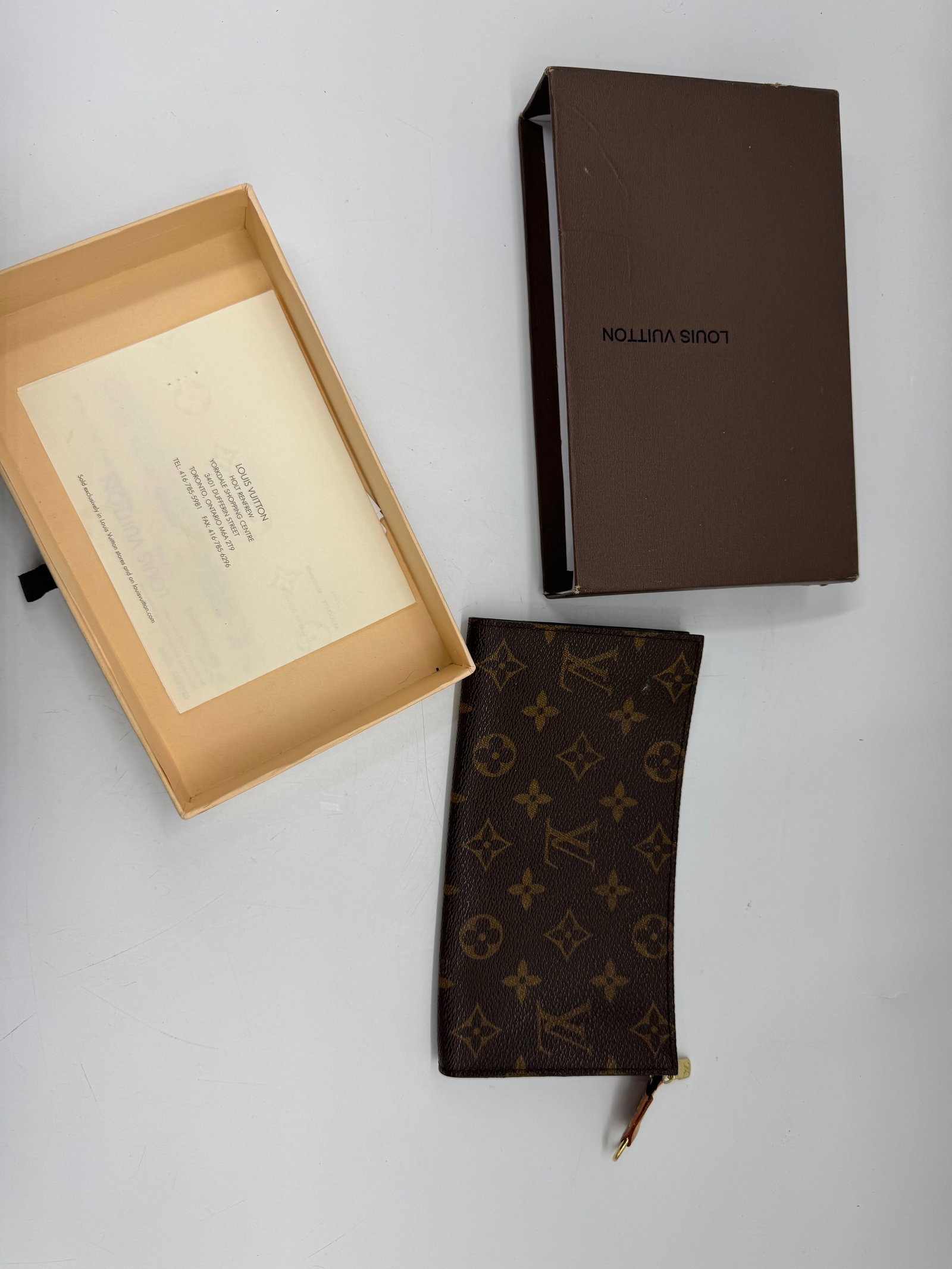 Louis Vuitton Monogram Pochette with Box: Louis Vuitton Monogram Pochette. Includes original box and paperwork. Dimensions: 8 x 4.5 inches. Box dimensions: 8.5 x 5 inches.