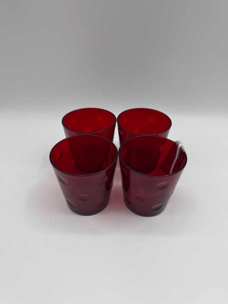 Set of Four Ruby Red Thumb Dot Pattern Glass Tumblers: Set of four ruby red glass tumblers. Each glass features a subtle, thumb dot pattern. A stylish addition to any barware collection.