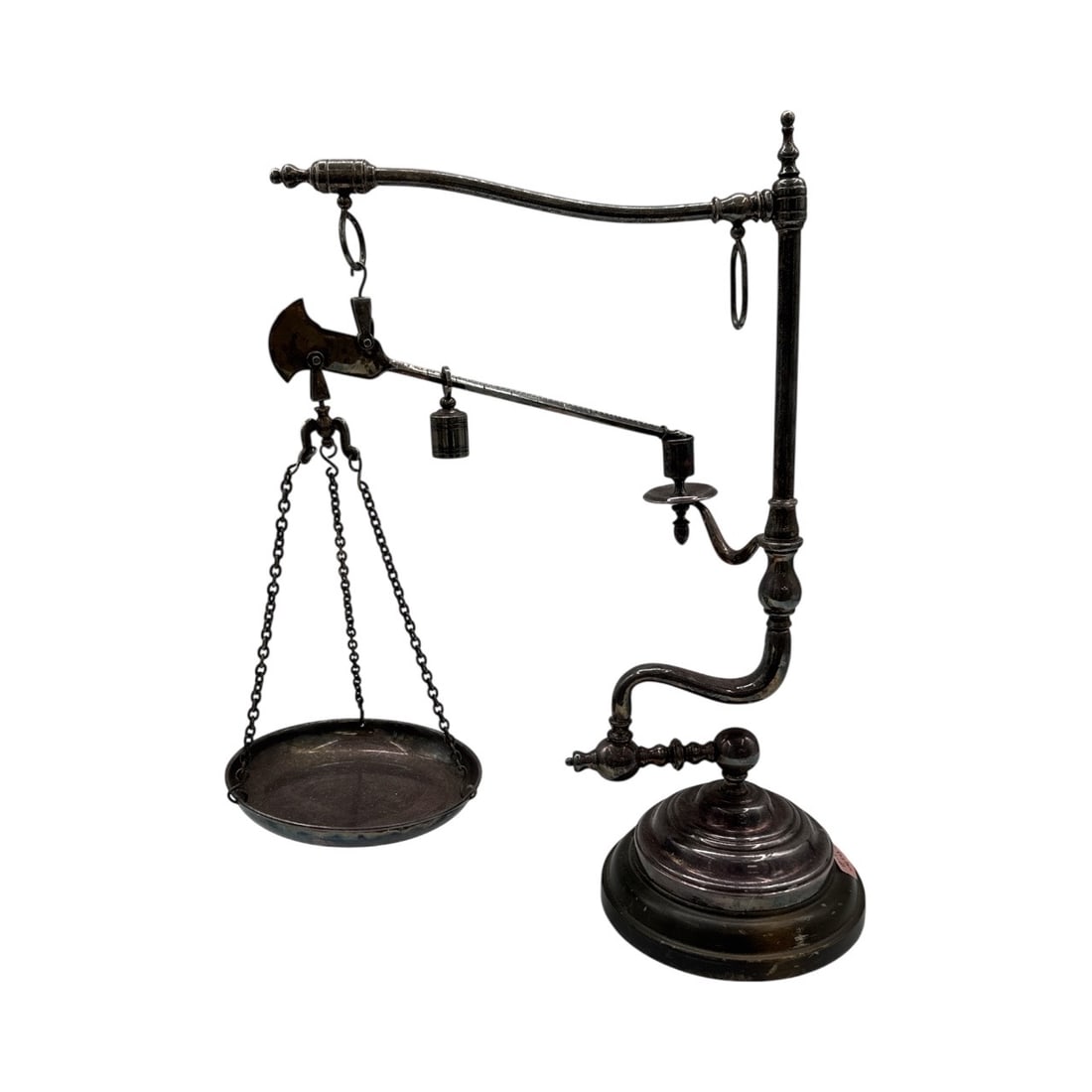 Antique Balance Scale: Antique balance scale featuring a circular pan suspended by chains, a counterweight, and an ornate stand. Dimensions: H:22in, L:18in, W:8in.