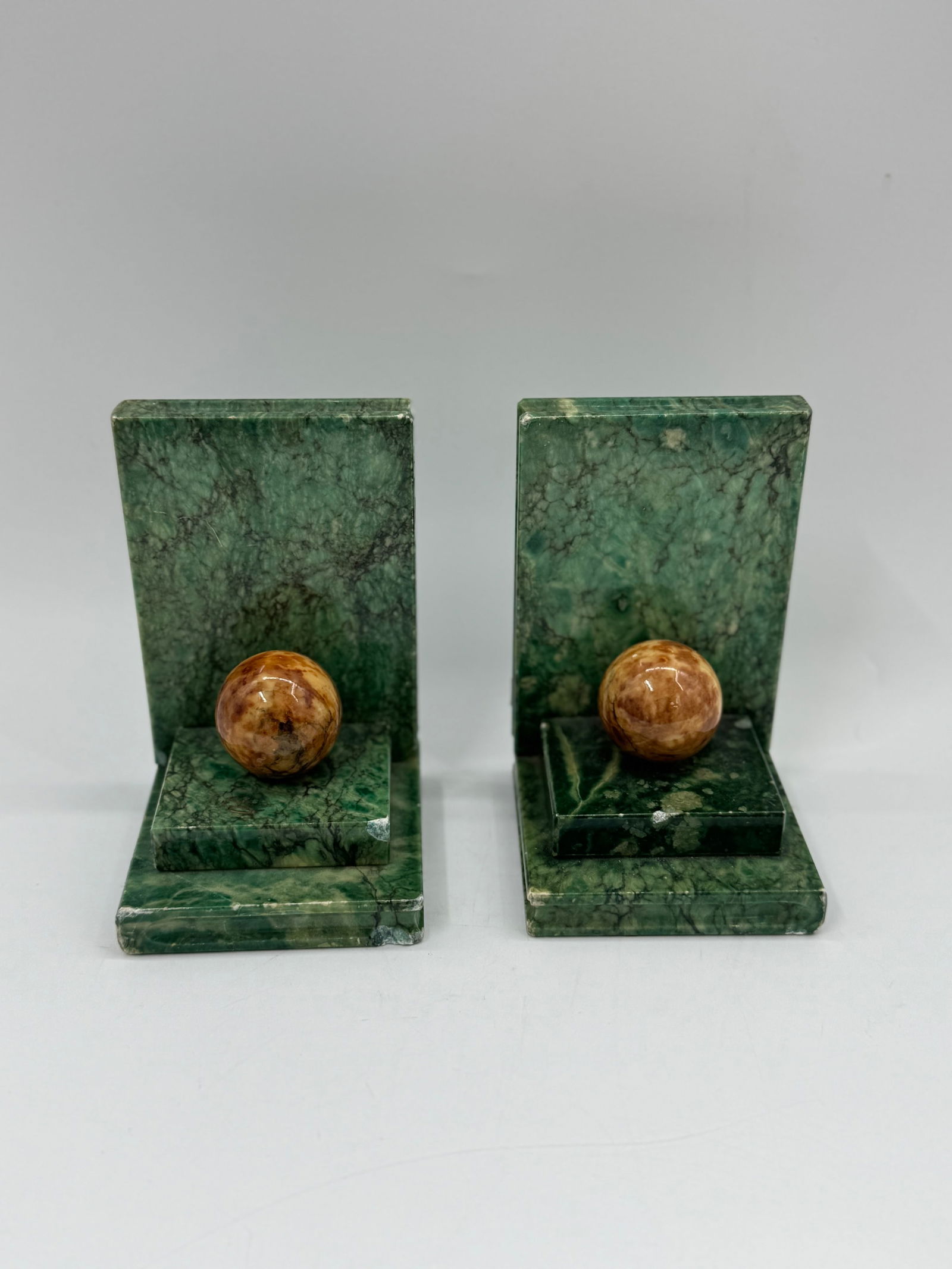 Pair of Green Marble Bookends with Spheres: Pair of green marble bookends, each featuring a stepped base and a decorative sphere. Classic design, suitable for various bookshelf styles.