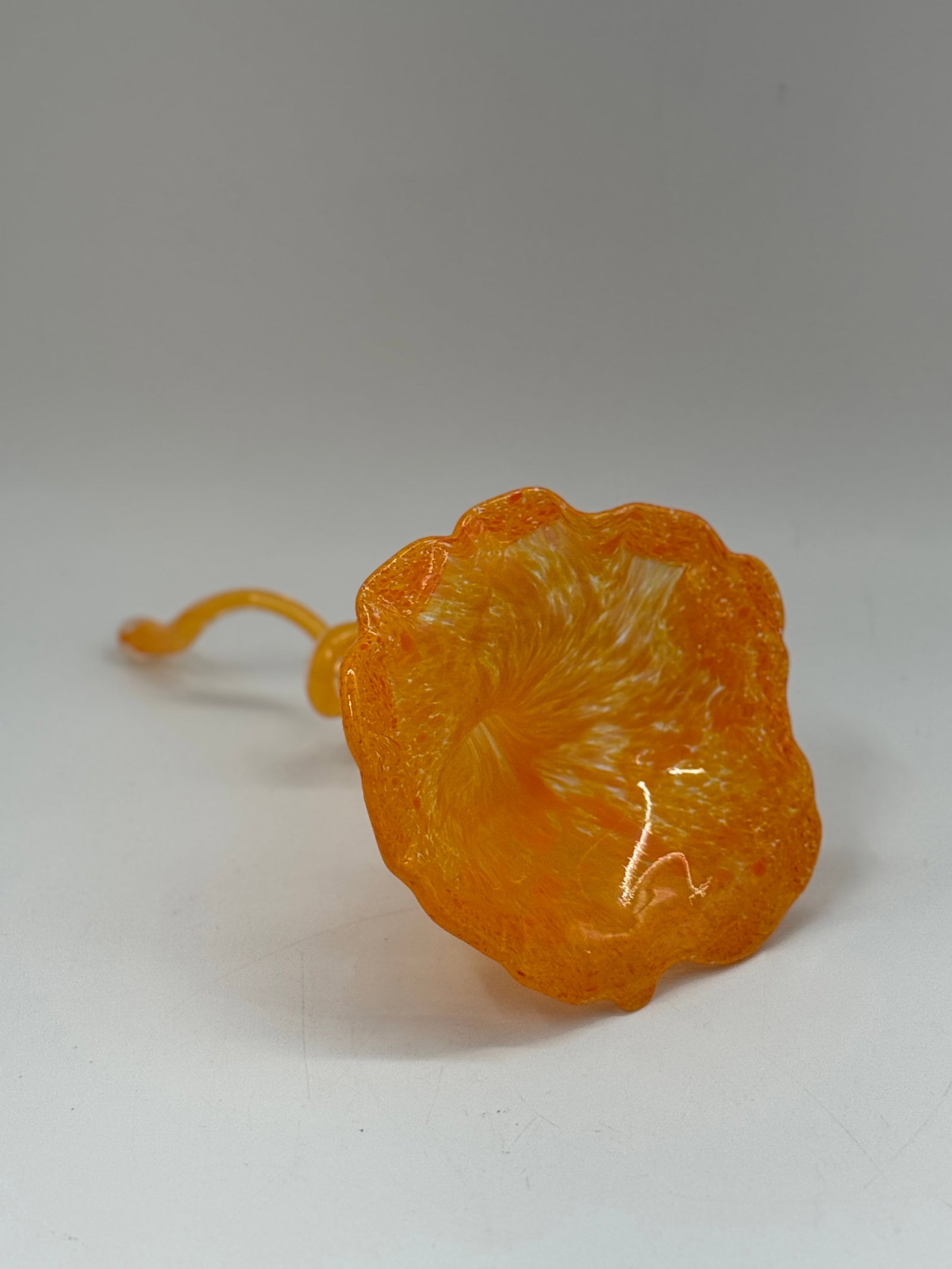 Orange Murano Style Glass Flower Sculpture: Hand-blown orange art glass flower sculpture. Features a textured petal design and a delicate, curled stem. Dimensions: 12 x 5.5 inches.