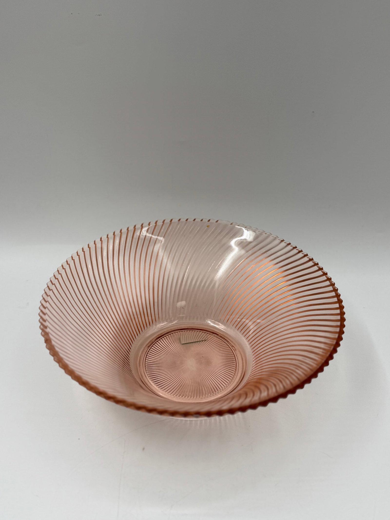 Pink Depression Glass Bowl, Swirl Design: A pink depression glass bowl featuring a swirl design. The bowl measures approximately 4 inches in height and 11 inches in diameter. A decorative and functional piece.