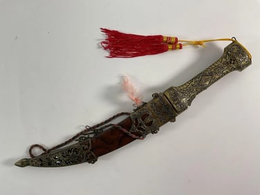 Ornate Decorative Dagger with Brass Detailing and Red Tassel
