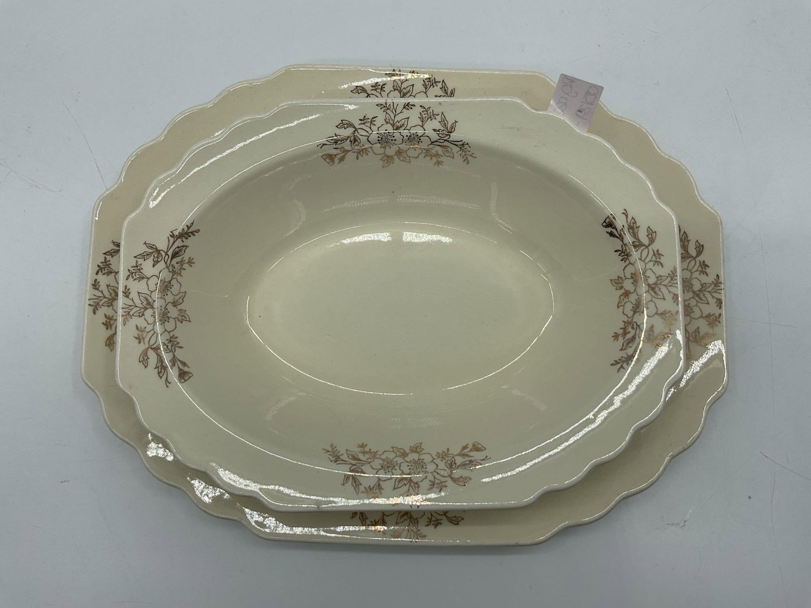 Scalloped Edge Serving Bowls with Gold Floral Design: Pair of vintage ivory-toned ceramic serving bowls with scalloped rims and delicate gold floral pattern. Ideal for formal dining or display. Dimensions: platter L:12in W:9in, bowl H:2in L:9in W:7in