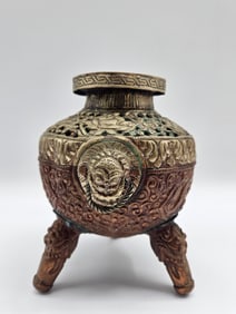Ornate Tripod Bronze Vessel with Mask Motifs