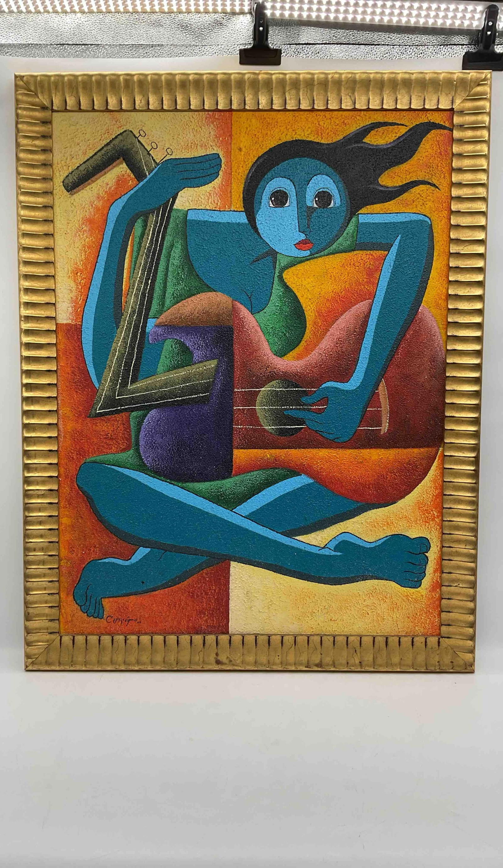 Framed Abstract Cubist-Style Painting by Cipriani: Bold and colorful abstract artwork depicting a blue-skinned figure with elongated limbs playing a guitar. The painting features strong cubist influences with fragmented shapes, vivid hues of blue, red