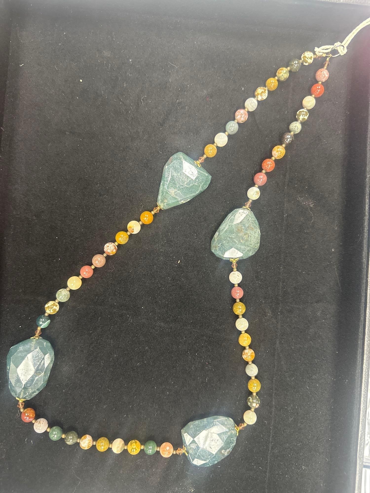 Dragon Jasper Beaded Necklace: Multicolor round beads paired with four large faceted green dragon jasper stones in a bold and vibrant design. Dimensions: L28in Medium: Semi-precious stone (dragon jasper), stringing wire
