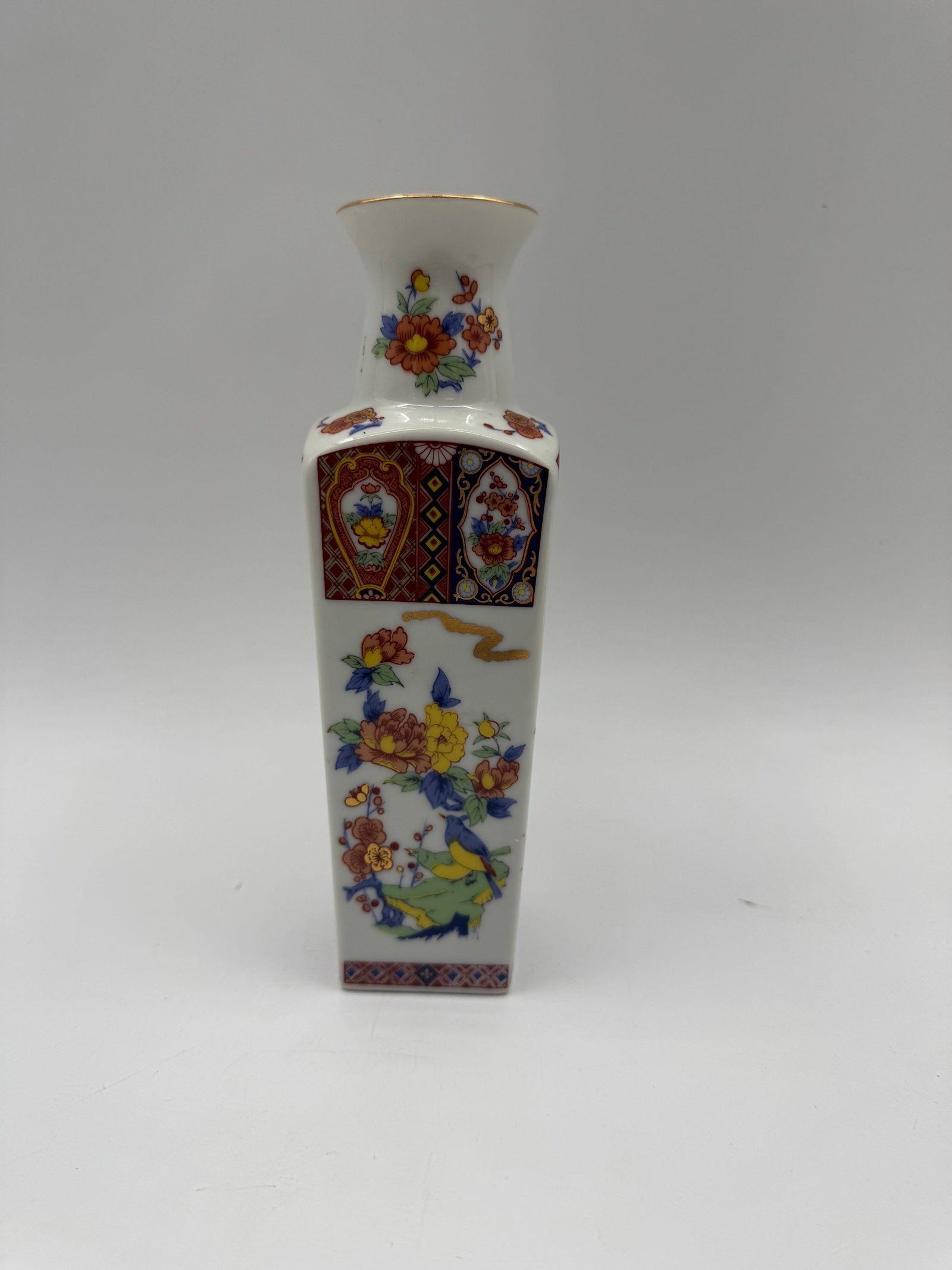 Japanese Imari Style Porcelain Vase: A Japanese Imari style porcelain vase featuring floral and geometric designs. Height: 8 inches, Length: 2 inches, Width: 2.5 inches.