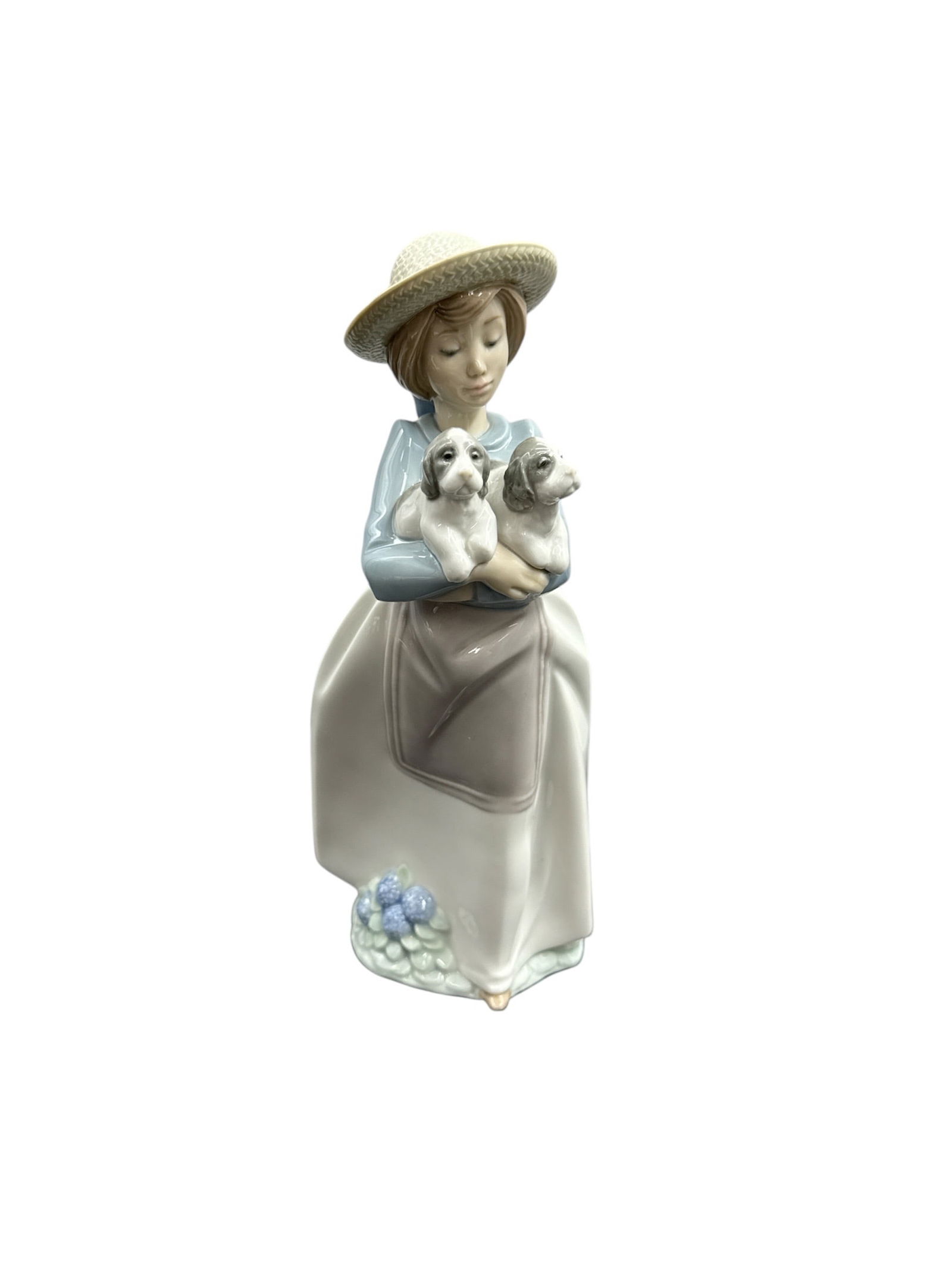Lladro Porcelain Figurine of Girl Holding Two Dogs, Spain: Refined Lladro porcelain figurine depicting a young girl dressed in a flowing gown and wide-brimmed hat, gently holding two small dogs in her arms. Crafted in Spain,