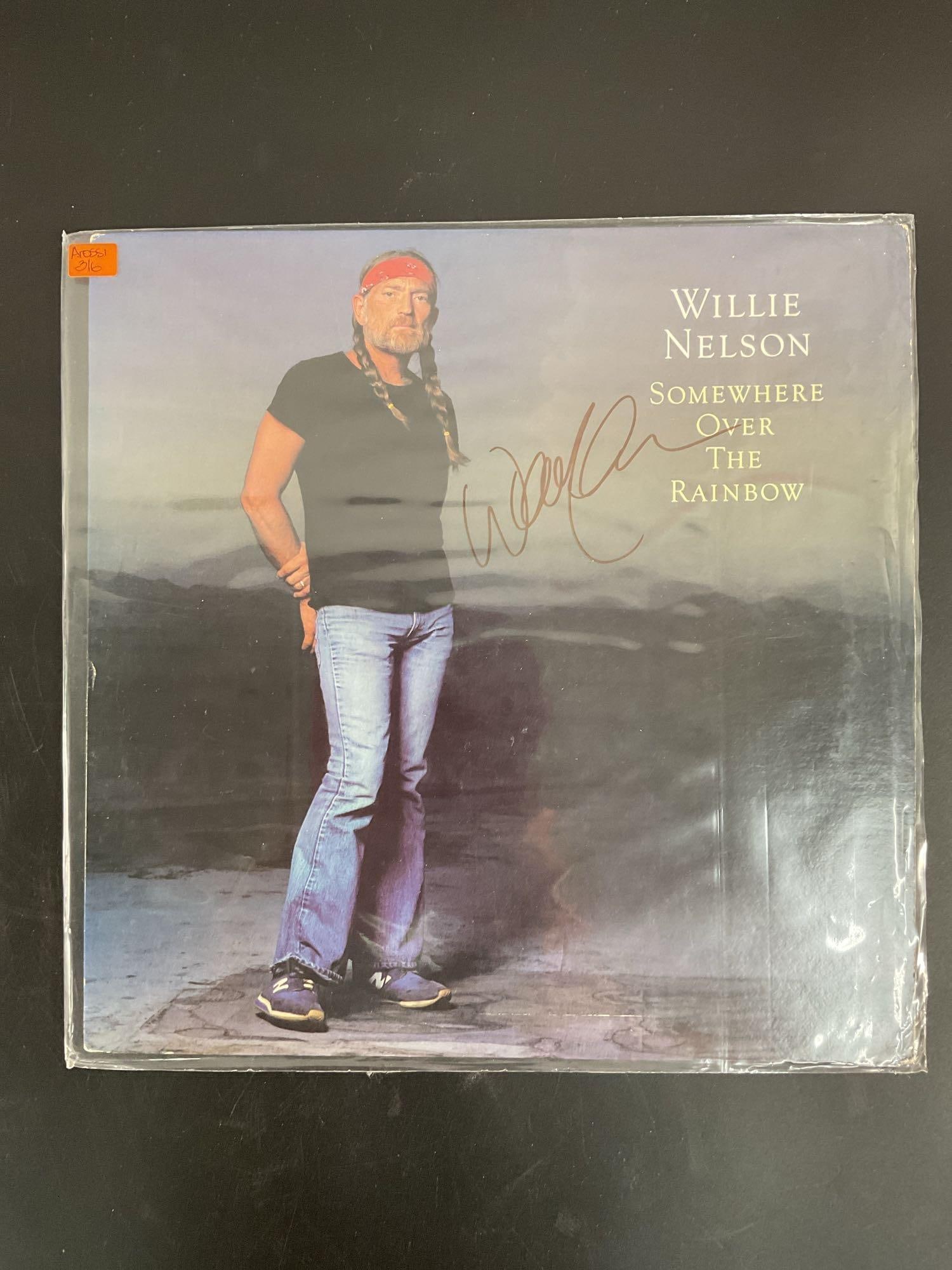 "Somewhere Over the Rainbow" by Willie Nelson Autographed Vinyl Record: This vinyl record features Willie Nelson's "Somewhere Over the Rainbow," showcasing his signature country style and smooth vocals. The album cover displays a striking image of Nelson, an