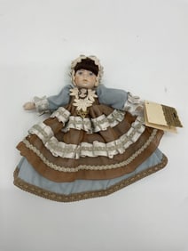 La Poulette Porcelain Doll with Cameo and Ruffled Dress