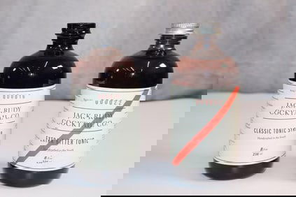 Two bottles of Jack Rudy Cocktail Co. Classic Tonic Syrup & Extra Bitter Tonic