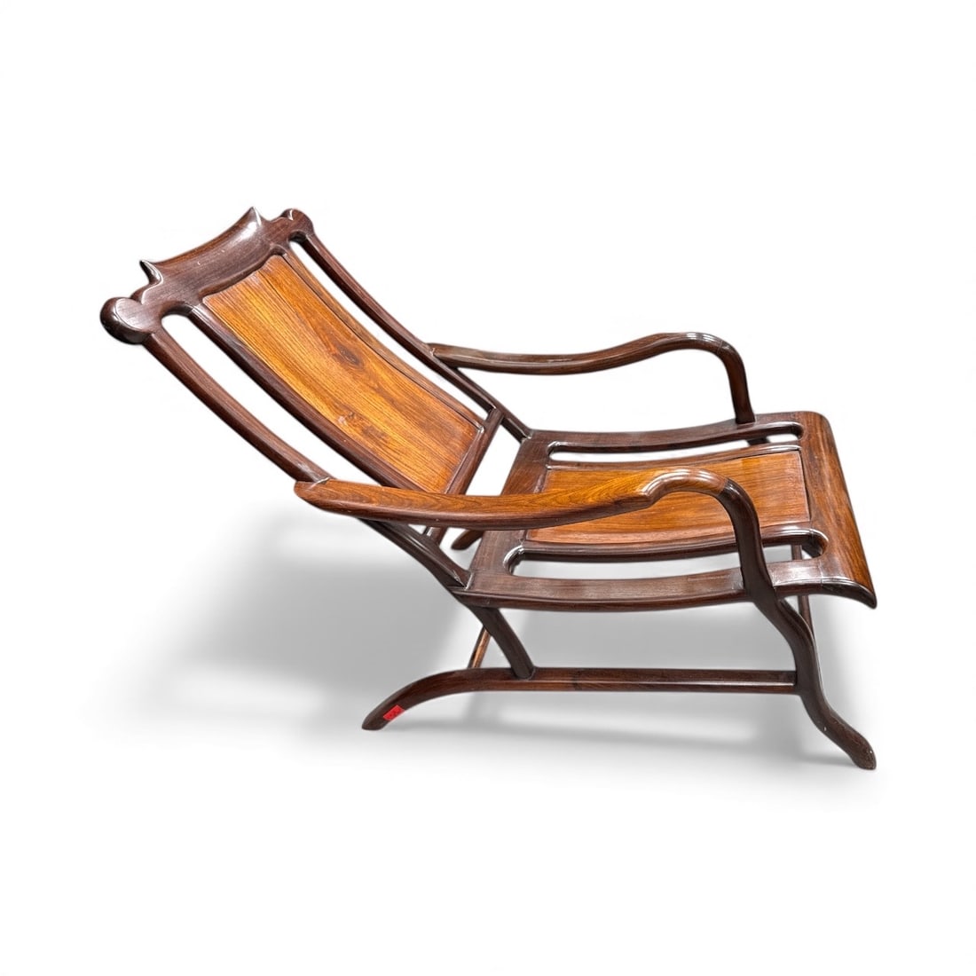 Antique Asian Hardwood Reclining Chair: Antique Asian hardwood reclining chair with curved arms and back. Dimensions: H:29in, L:42in, W:20in. Good condition.