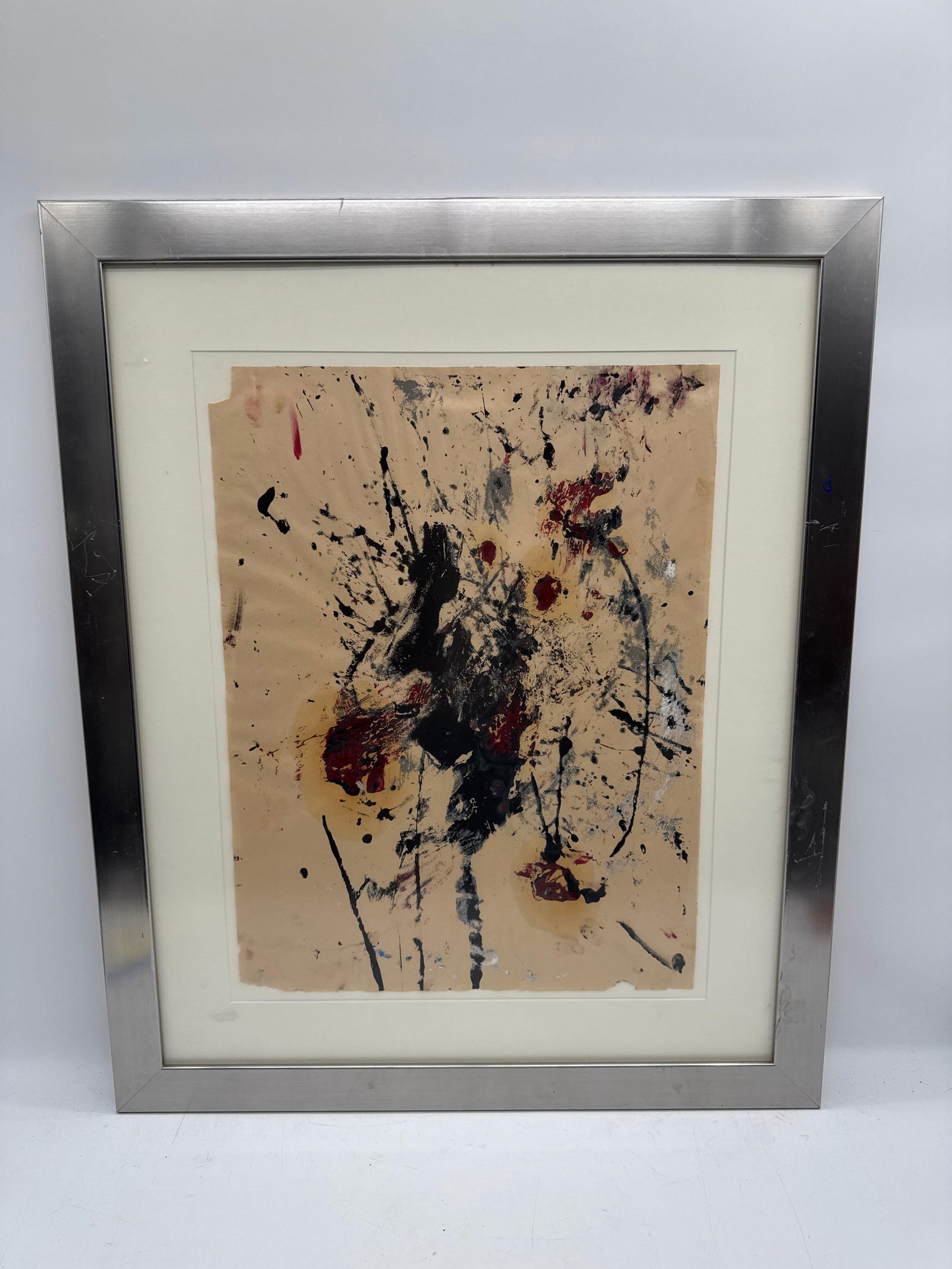 Abstract Expressionist Composition with Black and Red by Carlos Felix (Mexico, B. 1981): Expressive abstract painting on handmade beige paper, featuring vigorous splatters and layered strokes in black, deep red, and gray with subtle textural variations. The raw energy and gestural movemen