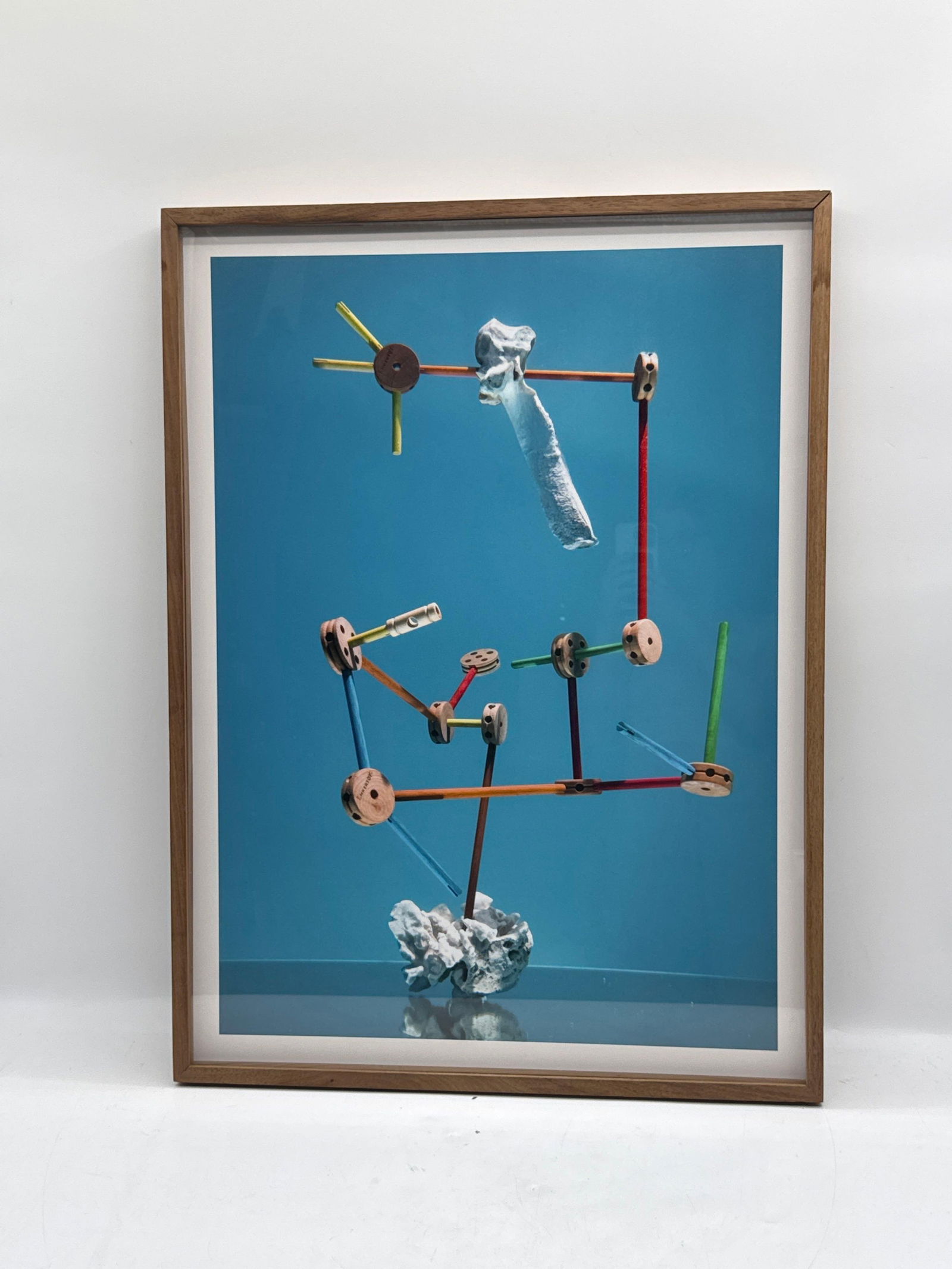 Alejandro Almanza (Mexico, b.1977) Mixed Media: Unique framed artwork by Mexican artist Alejandro Almanza featuring a surreal assemblage against a vibrant blue background. The composition includes brightly colored wooden toy connector pieces, geome