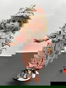 Porcelain Doll in Bear Patch Overalls: This porcelain doll has curly blonde hair, large brown eyes, and a softly surprised expression. She is dressed in a vintage-style outfit featuring pink corduroy overalls with adorable bear face patche