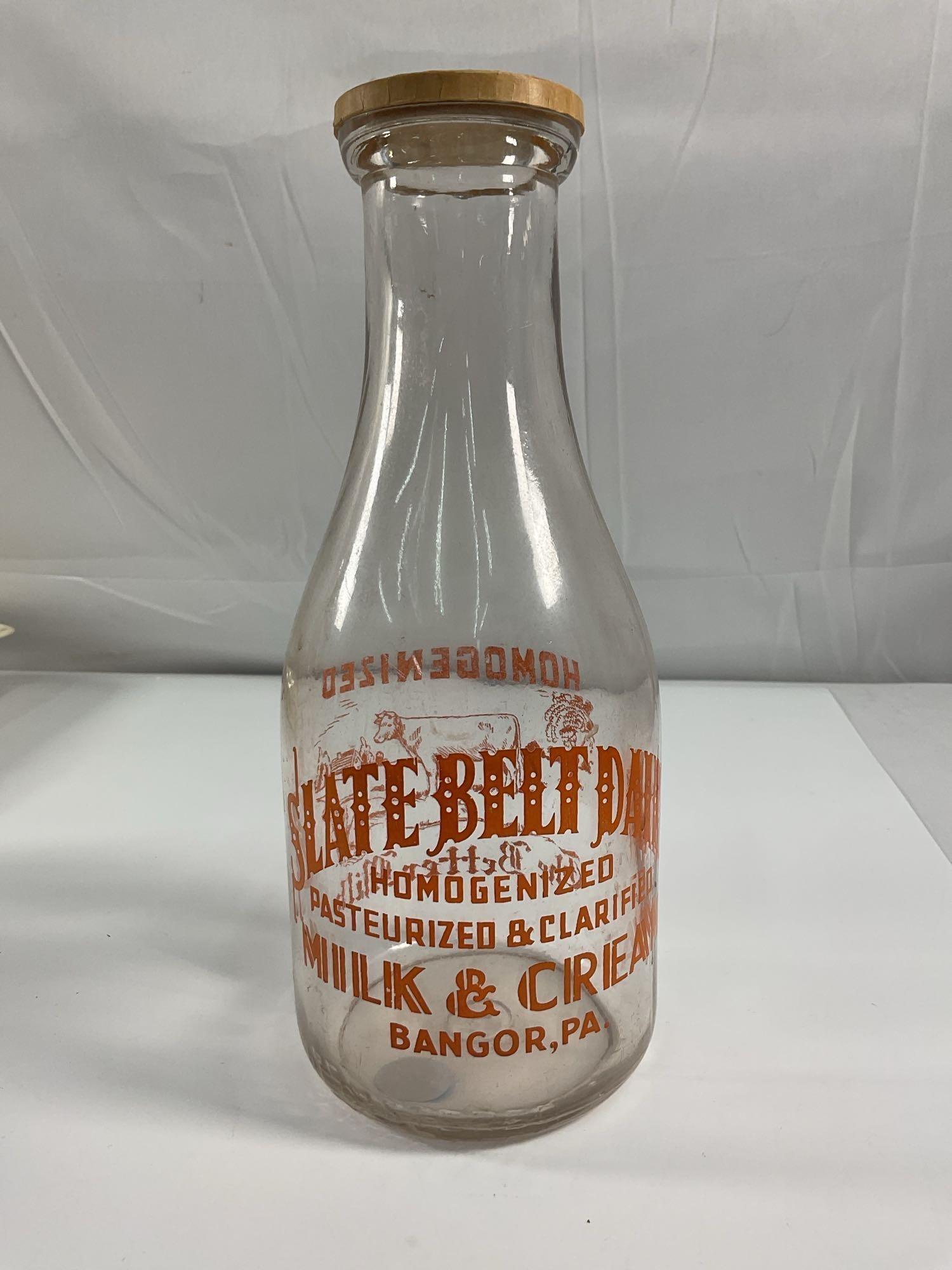 Slate Belt Dairy Milk Bottle - Box 5 - Photo 13:  A clear glass milk bottle from Slate Belt Dairy, located in Bangor, PA. The bottle features bold orange lettering advertising "Homogenized, Pasteurized & Clarified Milk &