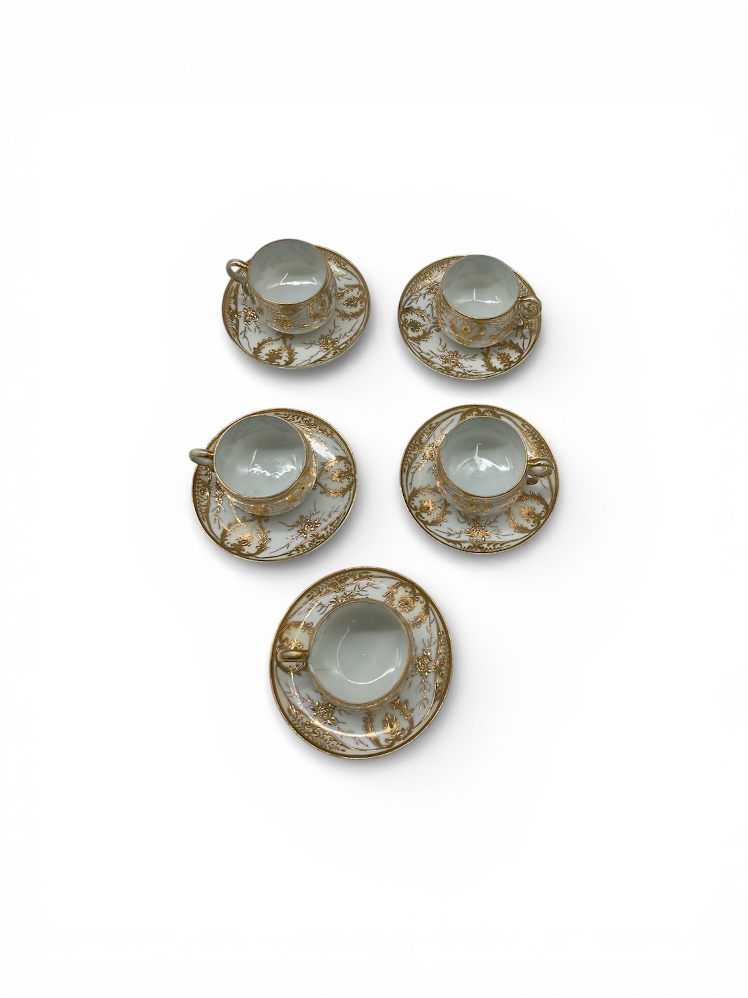 Set of 5 Antique Nippon Hand Painted Gilt Porcelain Demitasse Cups and Saucers: This elegant set of five demitasse cups and matching saucers showcases the intricate artistry of early 20th-century Nippon porcelain. Each piece is meticulously hand-painted with a heavy gold