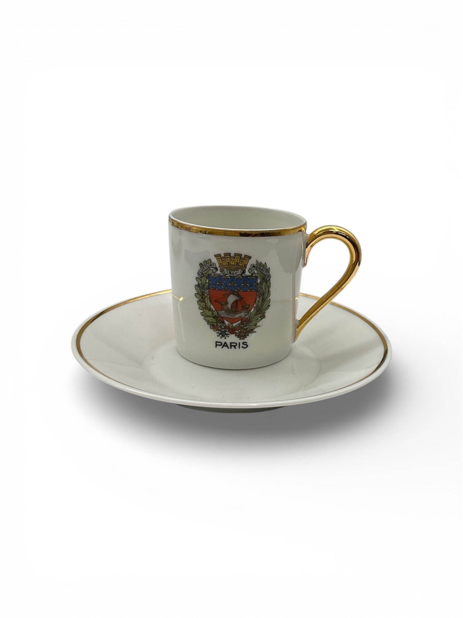 Limoges France Paris Heraldic Porcelain Demitasse Cup and Saucer Set: This refined porcelain demitasse cup and saucer set was produced in Limoges, France and features a Paris heraldic crest to the front of the cup, accented with rich color and fine detailing. The