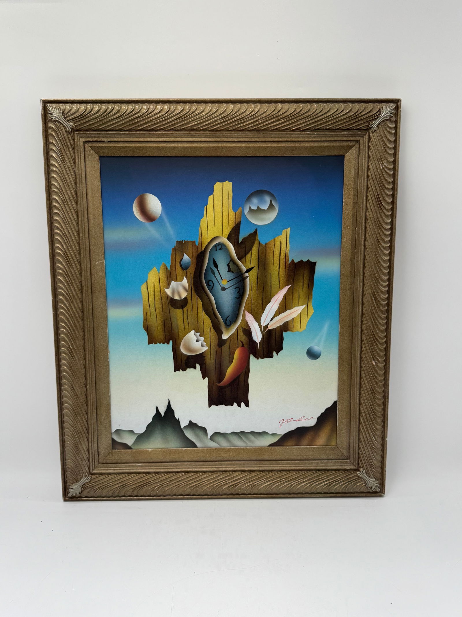 Surrealist Melting Clock Salvador Dali Style Oil Painting: Description: Oil painting featuring a surrealist melting clock motif, reminiscent of Salvador Dali. The painting is set against a blue sky and desert landscape. Framed. Medium: Oil on canvas Di