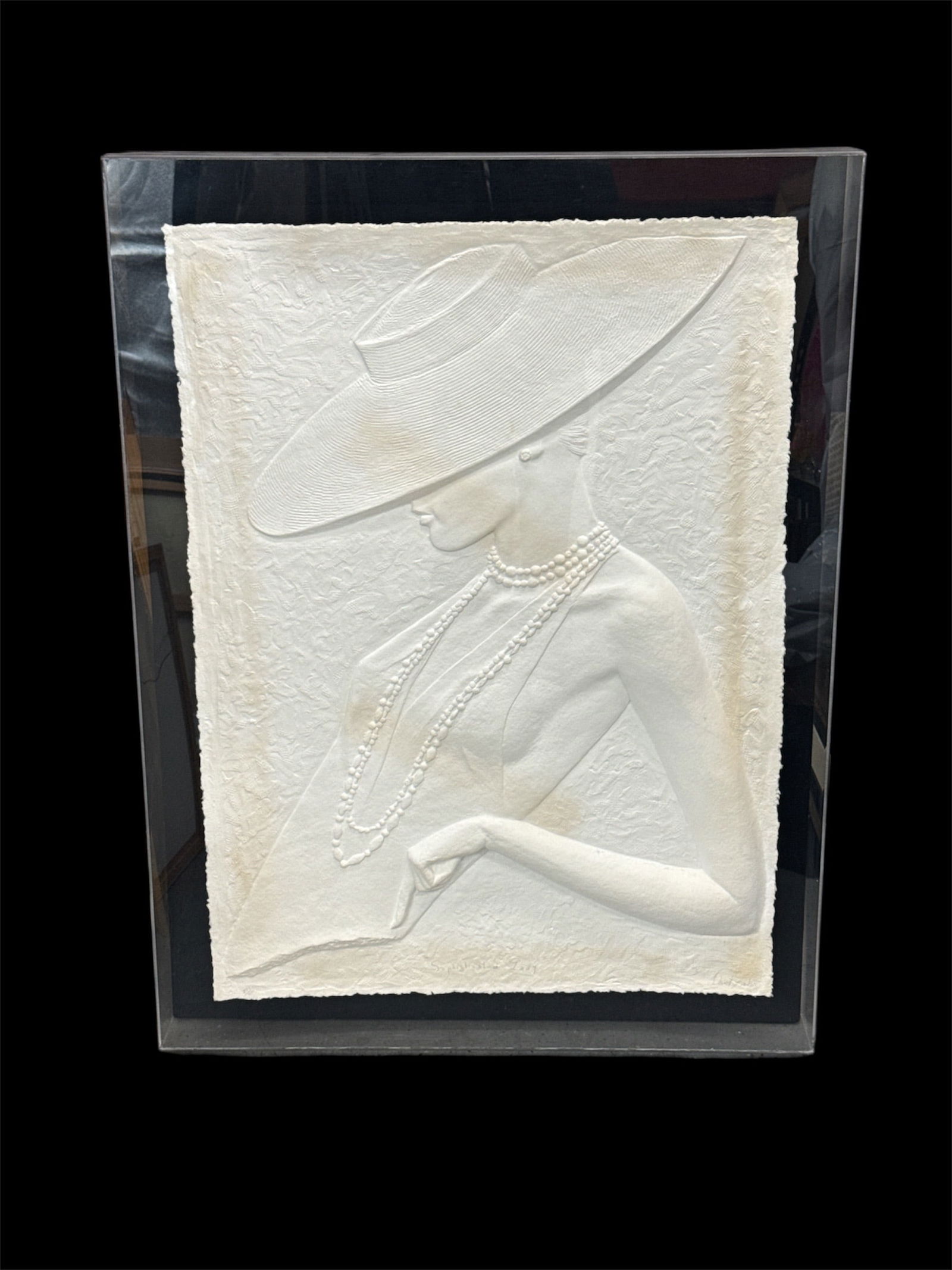 Large White Bas-Relief Figural Wall Sculpture of Elegant Woman: This lot features a large-scale white bas-relief figural wall sculpture depicting an elegant woman wearing a wide-brimmed hat and layered pearl necklaces. The sculptural composition emphasizes