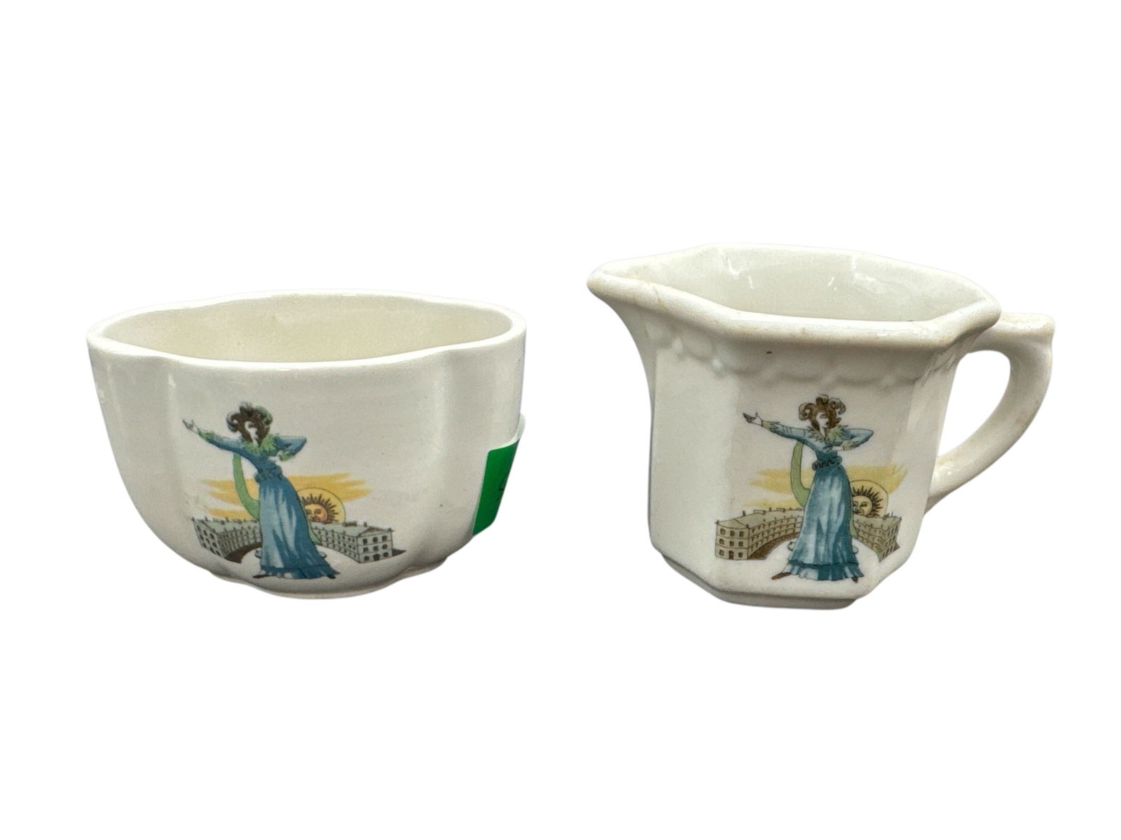 Grindley Duraline England Creamer and Sugar Set: This lot features a matching creamer and sugar bowl set produced by Grindley Hotelware Co of England in their Duraline super vitrified ceramic. Both pieces are decorated with a stylized figural motif