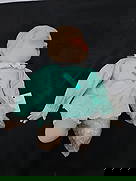 Vintage Porcelain Baby Doll, 11" H: Vintage porcelain baby doll with painted features and light blue clothing with lace trim. Measures approximately 11 inches in height and 10 inches in width at its widest point. Some parts are wrapped