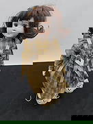 Porcelain Doll with Brown Hair and Plaid Dress: Vintage porcelain doll featuring brown hair, brown eyes, and a handmade plaid dress with ribbon accents and lace-trimmed petticoat. Shoes and clothing show light age wear. 16 h 8 w at widest part