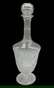 Saint-Louis Crystal Decanter: The decanter in the image is a Saint-Louis Tommy crystal decanter, a classic and timeless collection first created in 1928. Each piece is mouth-blown and hand-cut in France, showcasing the
