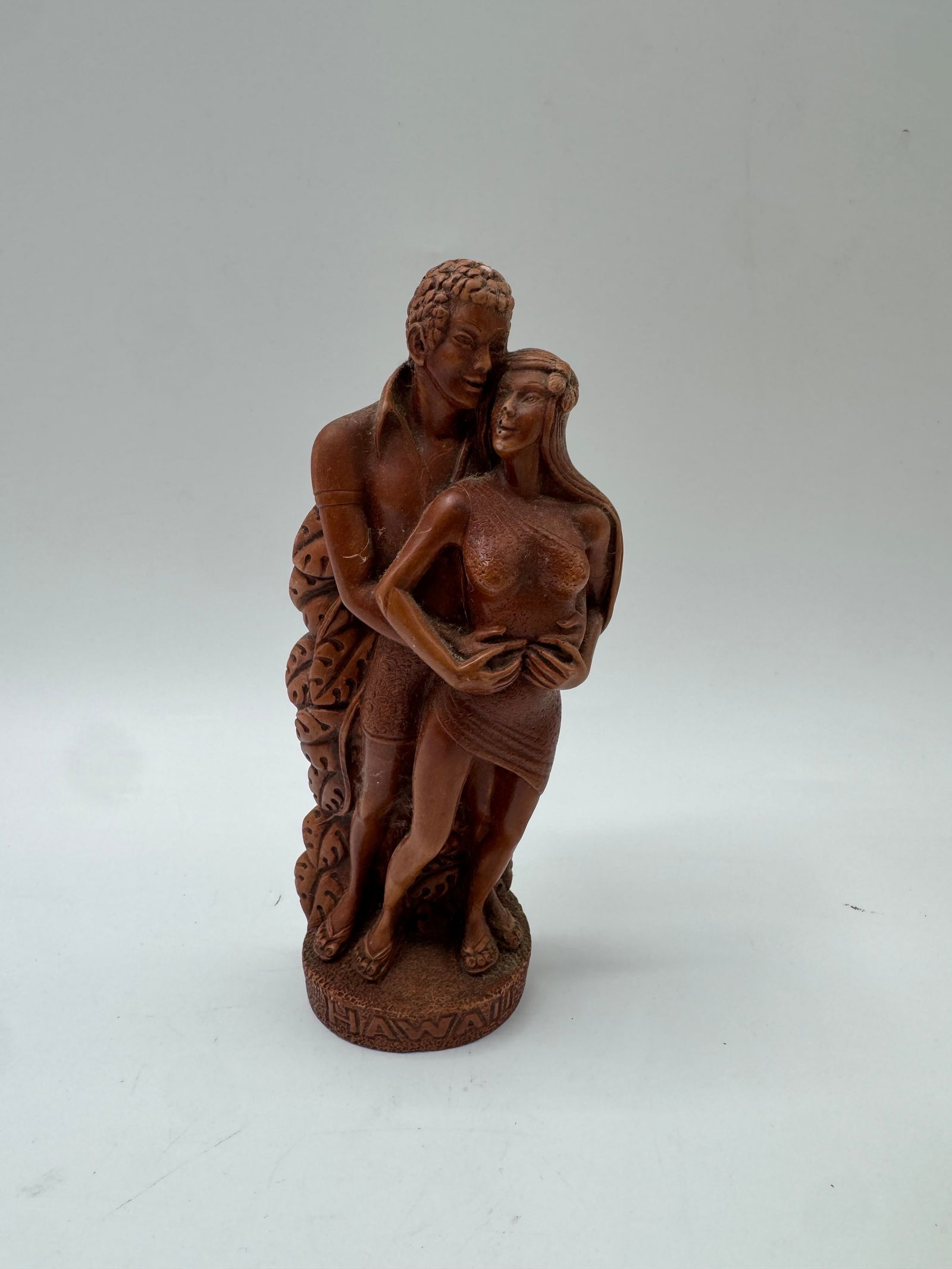 Hawaii Honeymooners Hardwood Sculpture: Vintage Hawaii Honeymooners hardwood sculpture. Depicts a couple embracing. Marked 'Made in Hawaii'. Measures approximately 7 x 3 inches. Good condition.