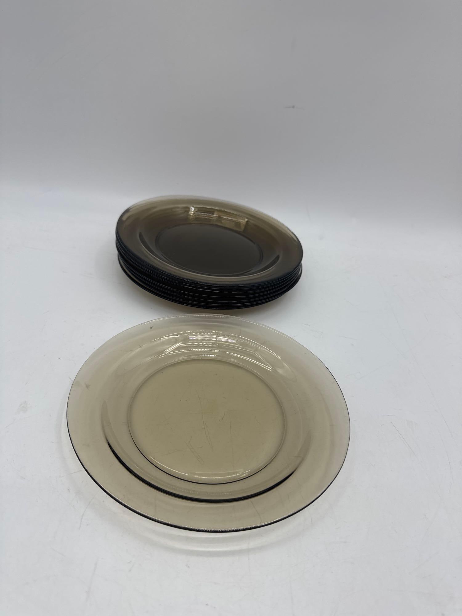 Set of 8 Vintage Amber Glass Plates: Collection of eight vintage amber glass plates in a clean, transparent finish. Includes a mix of medium and small sizes, ideal for serving or display. Classic mid-century modern style with a warm